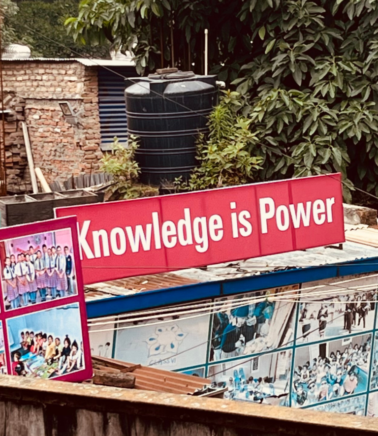 Ein Bild mit dem Text "Knowledge is Power" über bunten Wandgemälden.